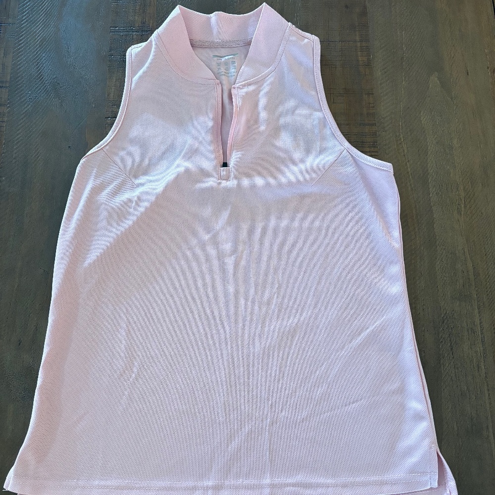 Women's light pink racerback polo.